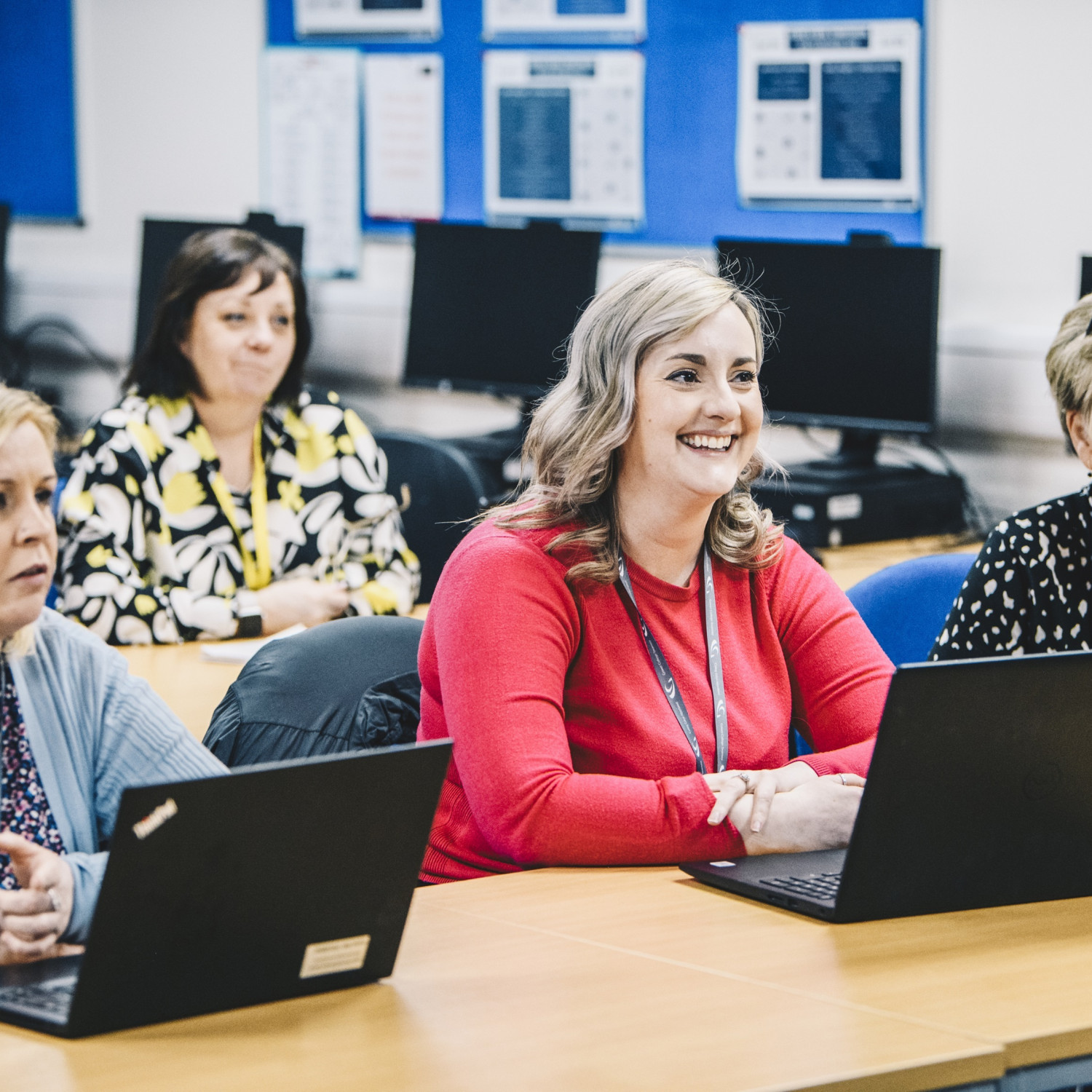 Students in a classroom environment with laptops on their desks