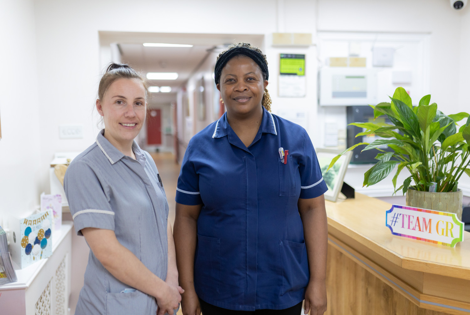 Two care home workers in uniform