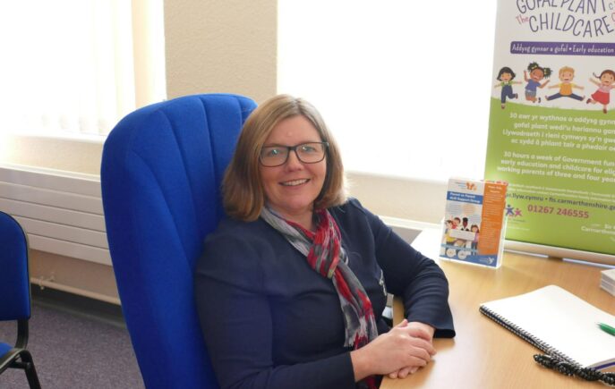 Susan James sitting at her desk