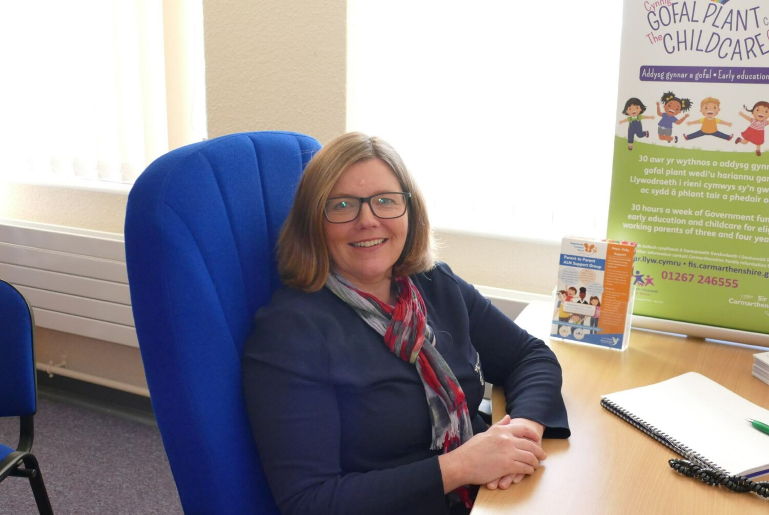 Susan James sitting down a desk