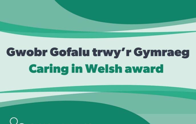 Text that says Gwobr Gofalu trwy'r Gymraeg/Caring in Welsh aware with Social Care Wales logo attached